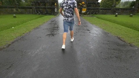 Man running through Candi Bentar gate in slow motion Stock Footage 85618292