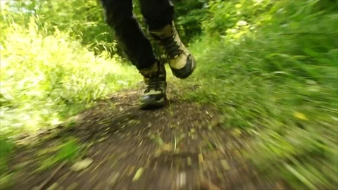 Man Running through Nature. Low Angle Boots Running through Forest Woodland Stock Footage 111236774