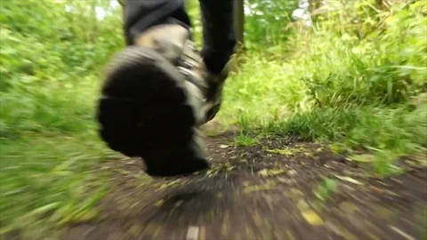 Man Running through Nature. Low Angle Boots Running through Forest Woodland Stock Footage 111236804