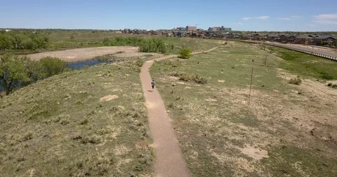MAN RUNNING THROUGH PARK Stock Footage 127887397