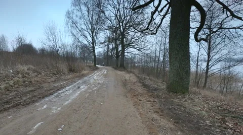 Man running through rural sandy road on a cloudy day in winter Stock Footage 58651320