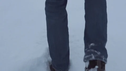 Man is running through the snow Stock Footage 83709912