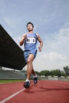 Man running on track Stock Photos