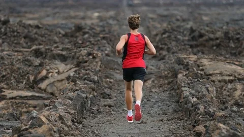 Man running - trail runner training on amazing lava waking trail on Hawaii Stock Footage 70275741