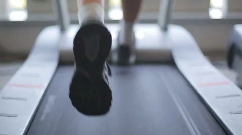 Man running on a treadmill. Close up shot Stock Footage