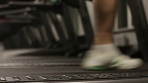 Man running on a treadmill. Close up shot. Focus on leg. Stock Footage 83129244