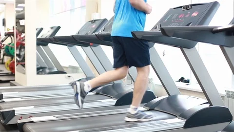 A man running on a treadmill in the gym Stock Footage 102227484