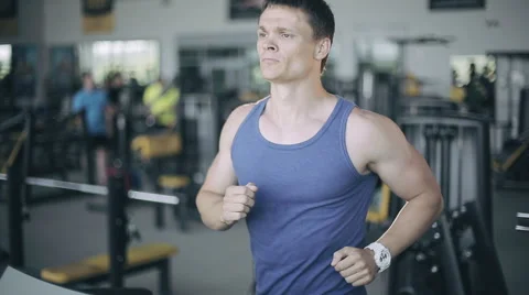Man running on the treadmill in the gym. Left 3/4 face portrait Stock Footage 52089667