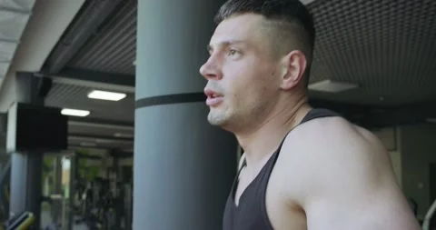 Man running on treadmill in gym. Men doing difficult cardio workout with air Stock Footage 130219601