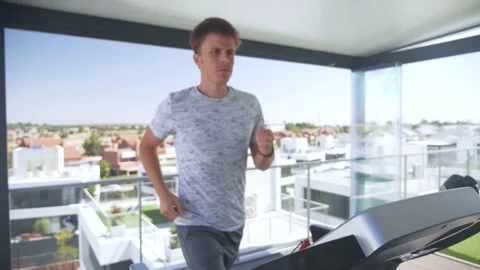 Man running with a treadmill on a rooftop Stock Footage 170885349