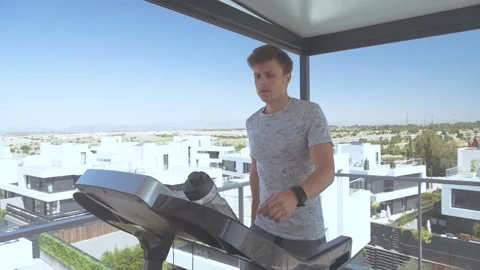 Man running with a treadmill on a rooftop Video stock 171084919