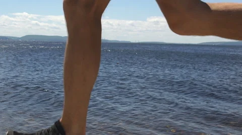 Man running on waterfront Stock Footage 68588968