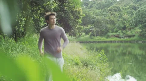 A man running at waterside Video stock 58994965