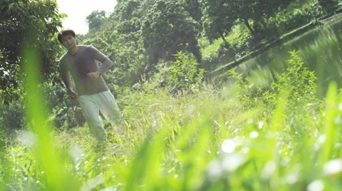 A man running at waterside Video stock 58995002