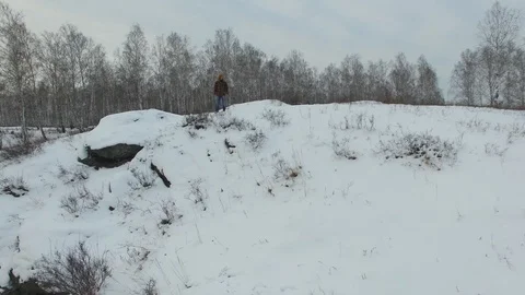 Man running on white winter forest road, top view drone aerial footage with Stock Footage 101044413