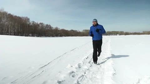 The man is running in winter Stock Footage 53313792