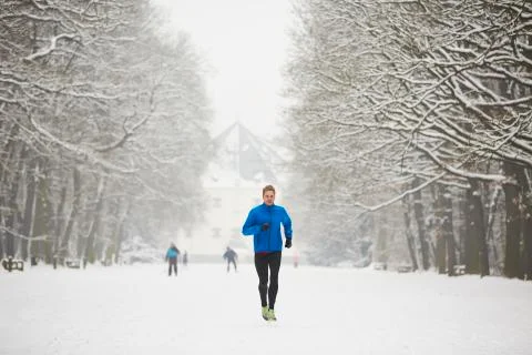 Man running in winter Stock Photos