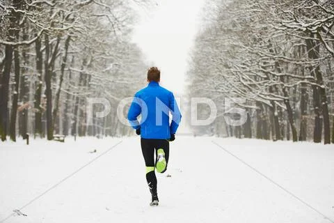 Man running in winter Stock Photos