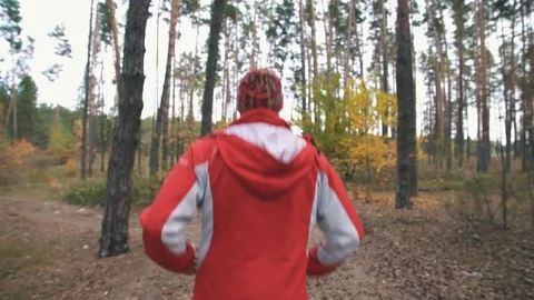 A man is running in the woods Stock Footage 82424403