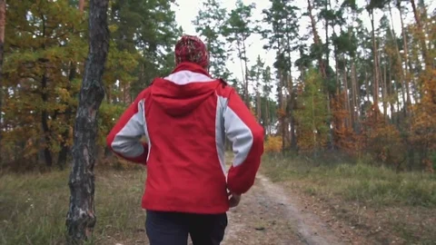 A man is running in the woods Stock Footage 82424628