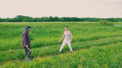 A man runs after a guy and swings an axe. Aerial photography. Stock Footage 311312604