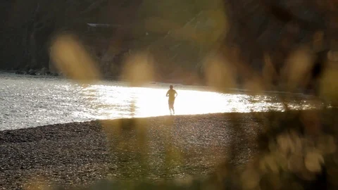Man runs along the coast Stock Footage 101972562