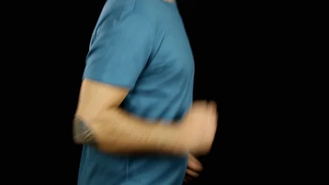 A man runs on a black background. No face. Stock Footage 157601731