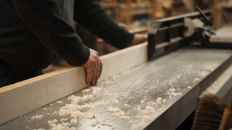 Man runs board through jointer machine closeup Stock Footage 102044939
