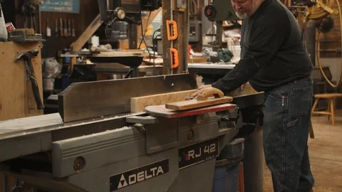 Man runs board through jointer machine Stock Footage 102044975