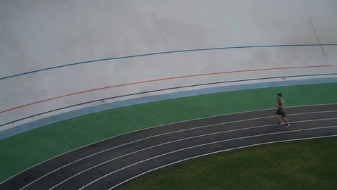 Man runs circles in the stadium Stock Footage 117545003
