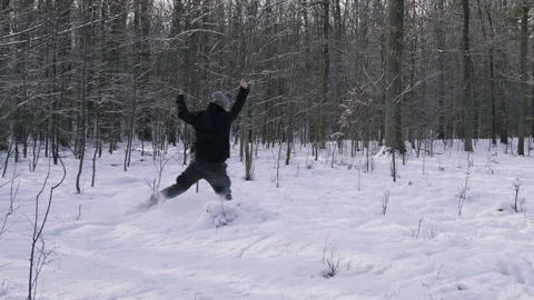 Man runs like crazy through the forest in the winter. Stock Footage 87346151