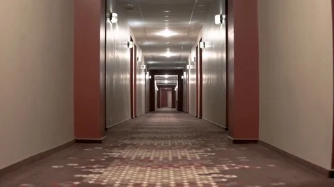 A man runs down the corridor barefoot in pajamas Vídeos de archivo 103677093