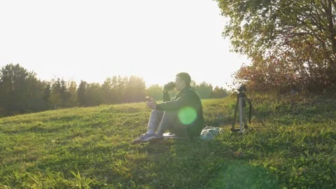 A man runs down a hill, throws off his backpack.  Stock Footage 242943271