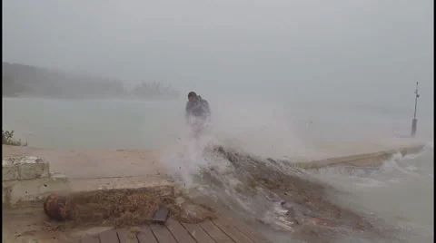 Man runs down pier during a hurricane Stock Footage 42958505