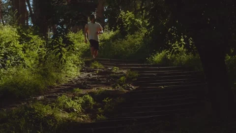 A man runs down the stairs, a man walks in the park, stairs in the park Vidéo 330201070