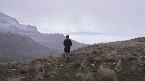 Man runs downhill through storm Stock Footage 65829357