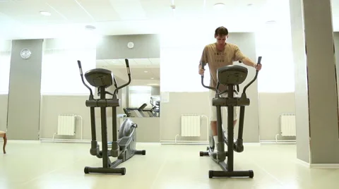 Man runs to the ellipsoidal simulator Stock Footage 52824172