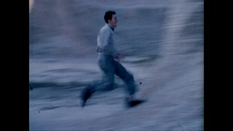 Man runs up a hill and does handstand Stock Footage 125838062