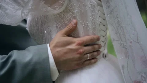 A man runs his hand over his woman’s dress. Close‑up shot of a hand. Stock Footage 343796857