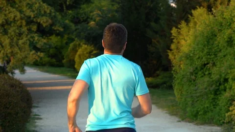 Man runs in the park Stock Footage 128978423