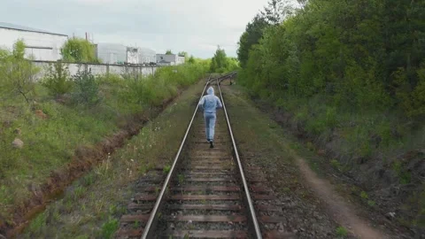 A man runs on rails forward Stock Footage 130844868