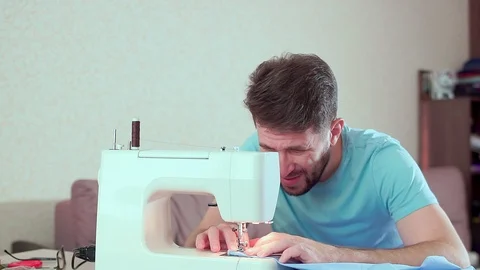 A man runs a sewing machine. Workplace at home 스톡 동영상 98786935