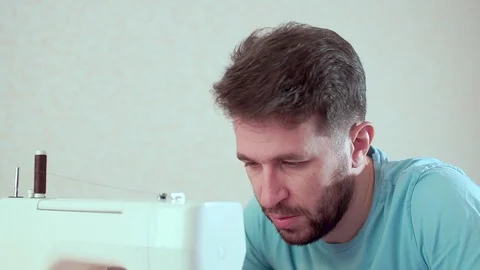 A man runs a sewing machine. Workplace at home. Close-up Видео 98787105