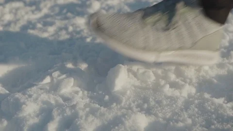A man runs sneakers close-up steps in the snow Stock Footage 102281334