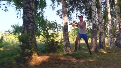 Man runs through a birch grove, overcoming obstacles, building endurance. Stock Footage 303254538