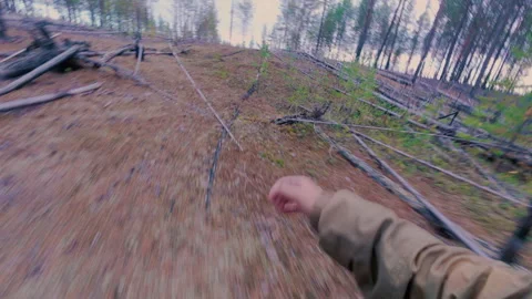 The man runs through the forest and runs out into the swamp. Stock Footage 318311171