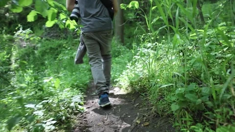 A man runs through a forest Stock Footage 130932871