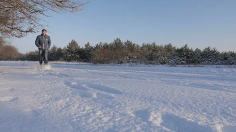 A Man Runs Through A Winter Forest In Deep Snow Stock Footage 122858377