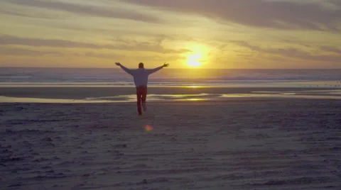 Man runs towards the sunset Stock Footage 59922764