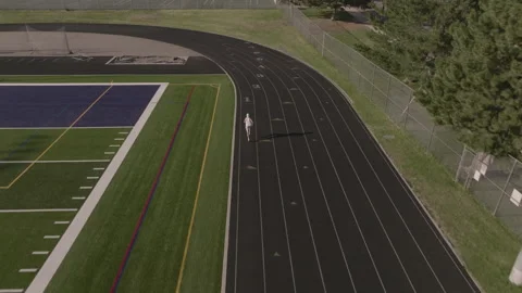 Man runs on track training for competition Stock Footage 221462569